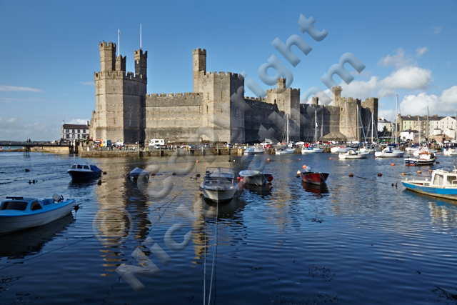 Gwynedd river tourist attraction Wales King Edward I defence rule conquest turret distinctive Prince battlements harbour boats blue